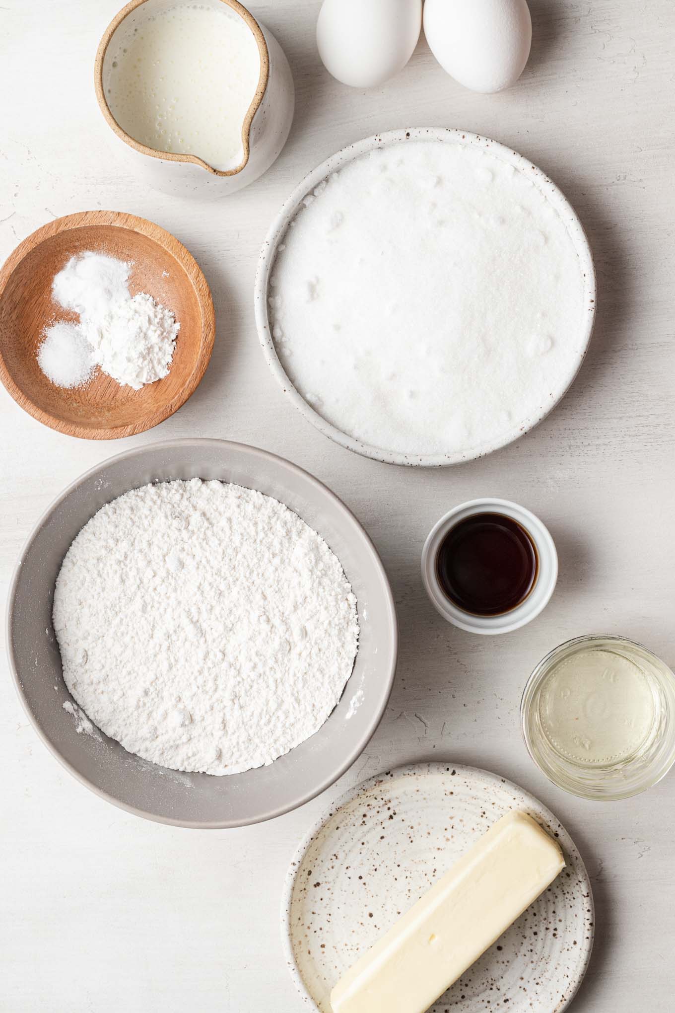 An overhead view of the ingredients needed to make a small vanilla cake. 