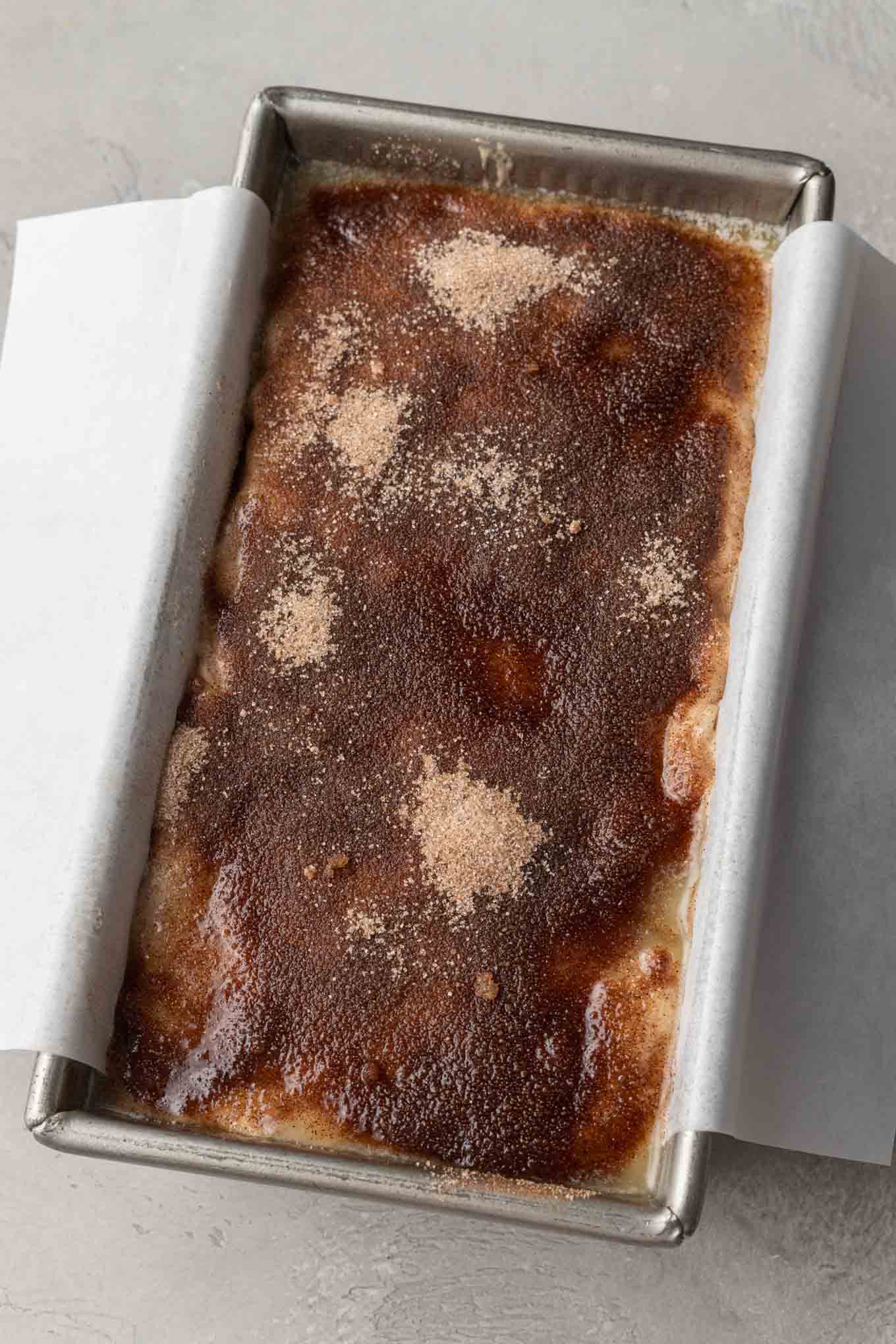 An overhead view of an unbaked loaf of apple bread. 