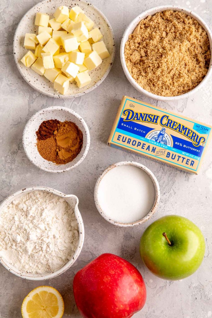 An overhead view of the ingredients needed to make this pie on a gray surface.