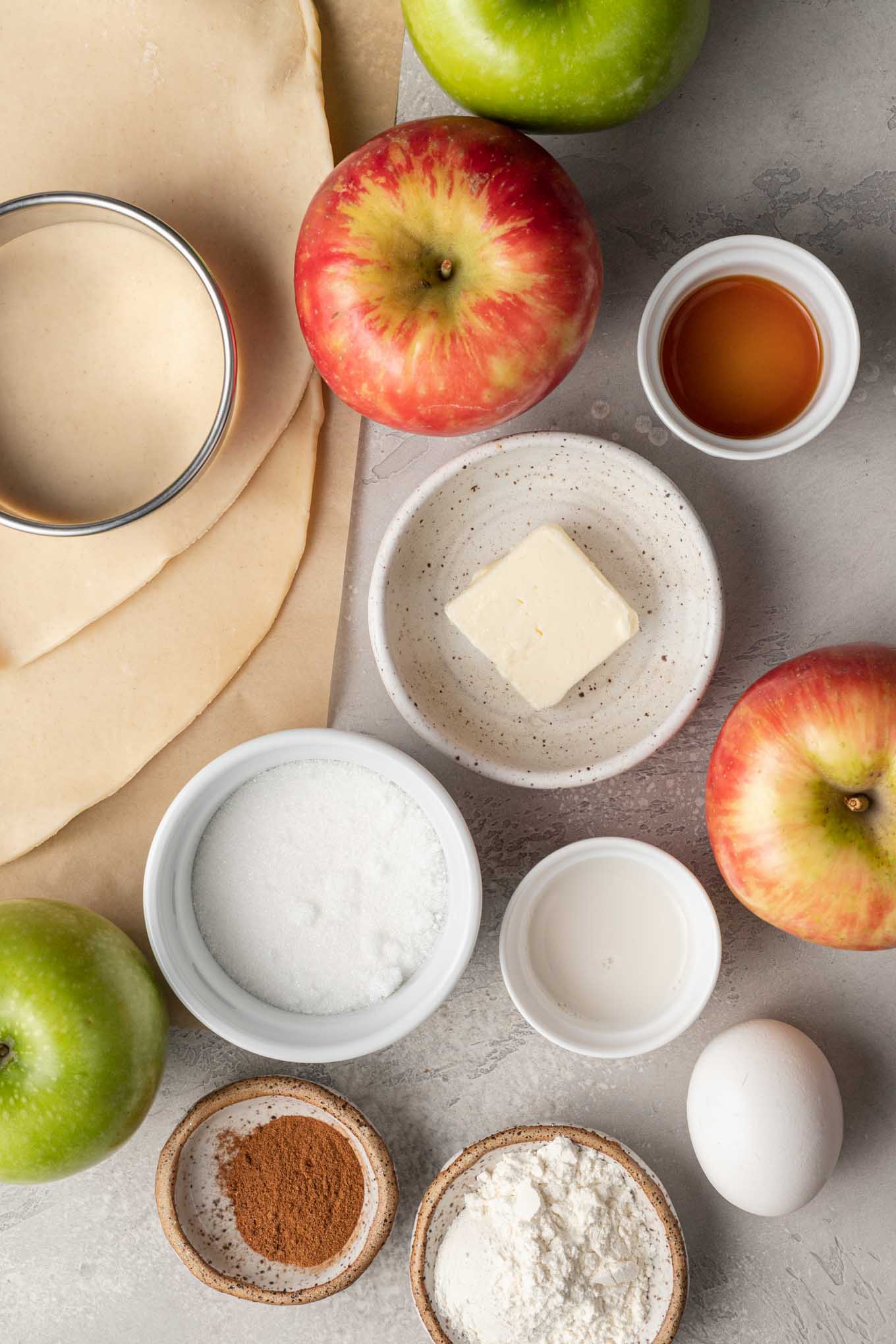 An overhead view of the ingredients needed to make hand held apple pies. 