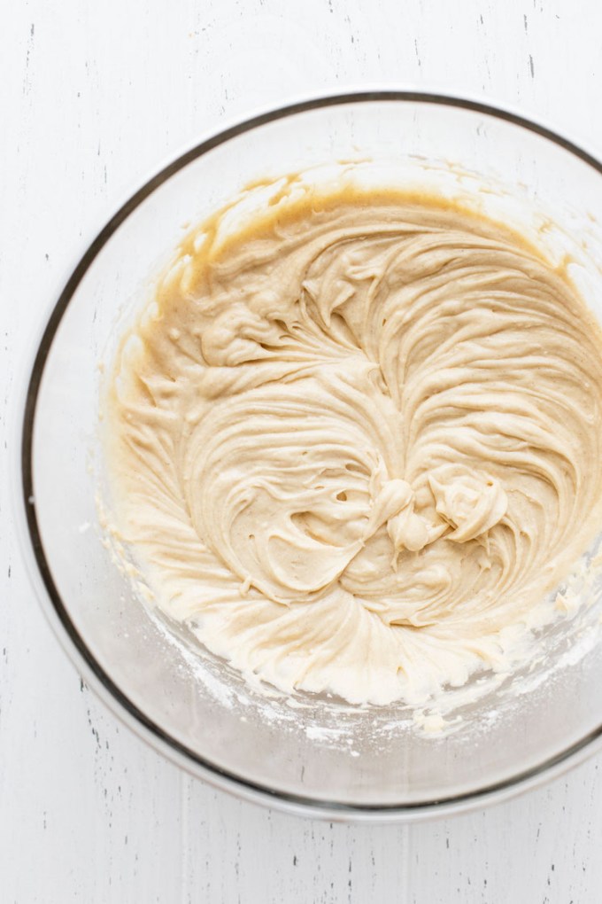 A glass mixing bowl holding the finished cake batter.