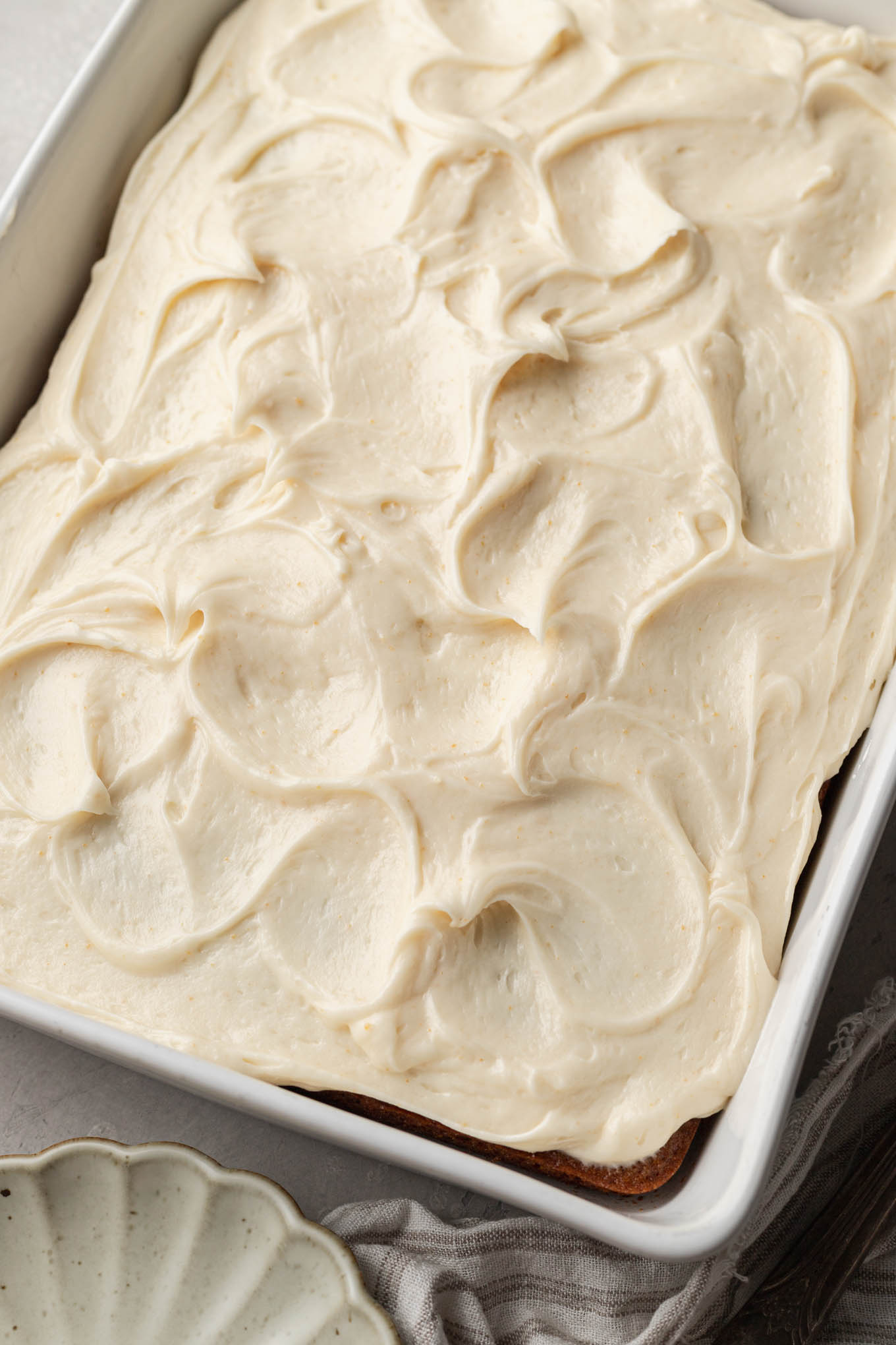 An overhead view of a frosted applesauce cake. 