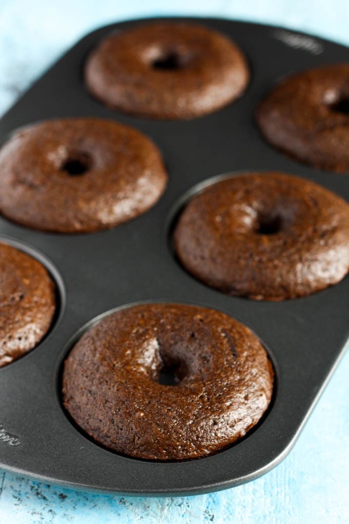 Baked chocolate cake donuts in a donut pan. 