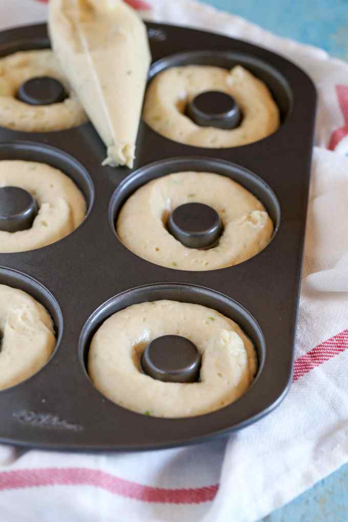 Key lime donut batter in a donut pan, ready to be baked. 