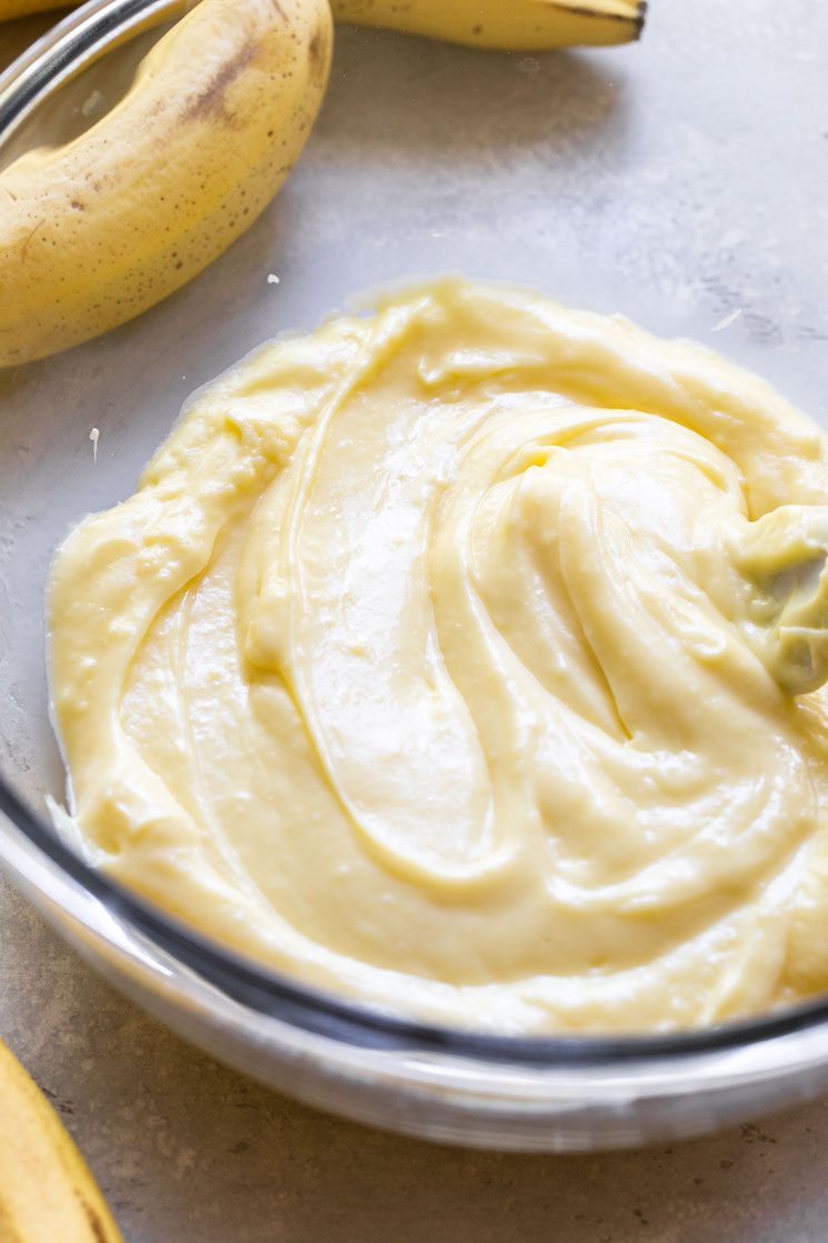 The creamy vanilla filling in a glass mixing bowl ready to pour into the prepared pie crust.