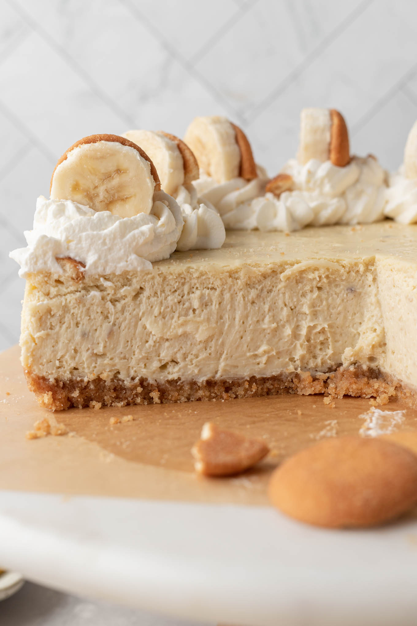 A side view of a sliced banana cheesecake. 