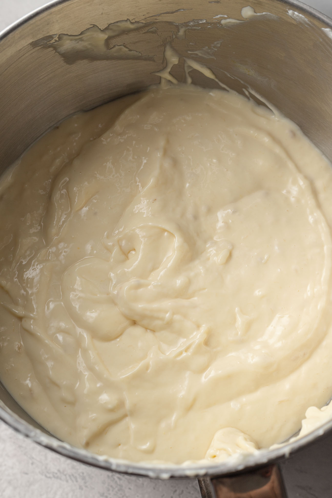 Banana cheesecake filling in a mixing bowl, seen from above.