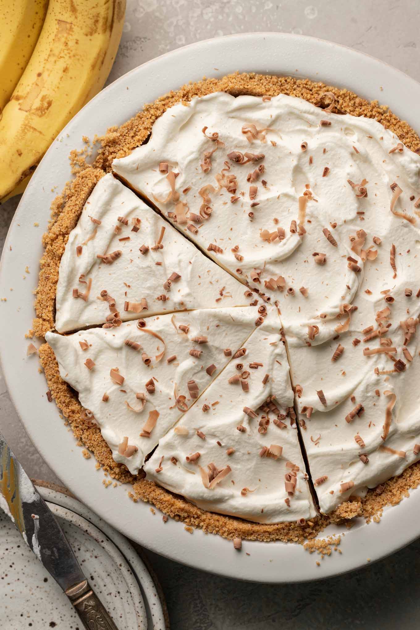 An overhead view of a sliced banoffee pie. 