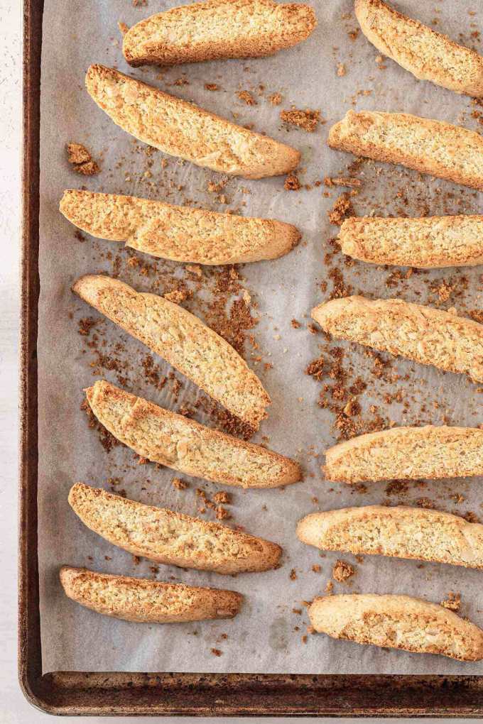 An overhead view of classic biscotti cookies on a baking sheet.