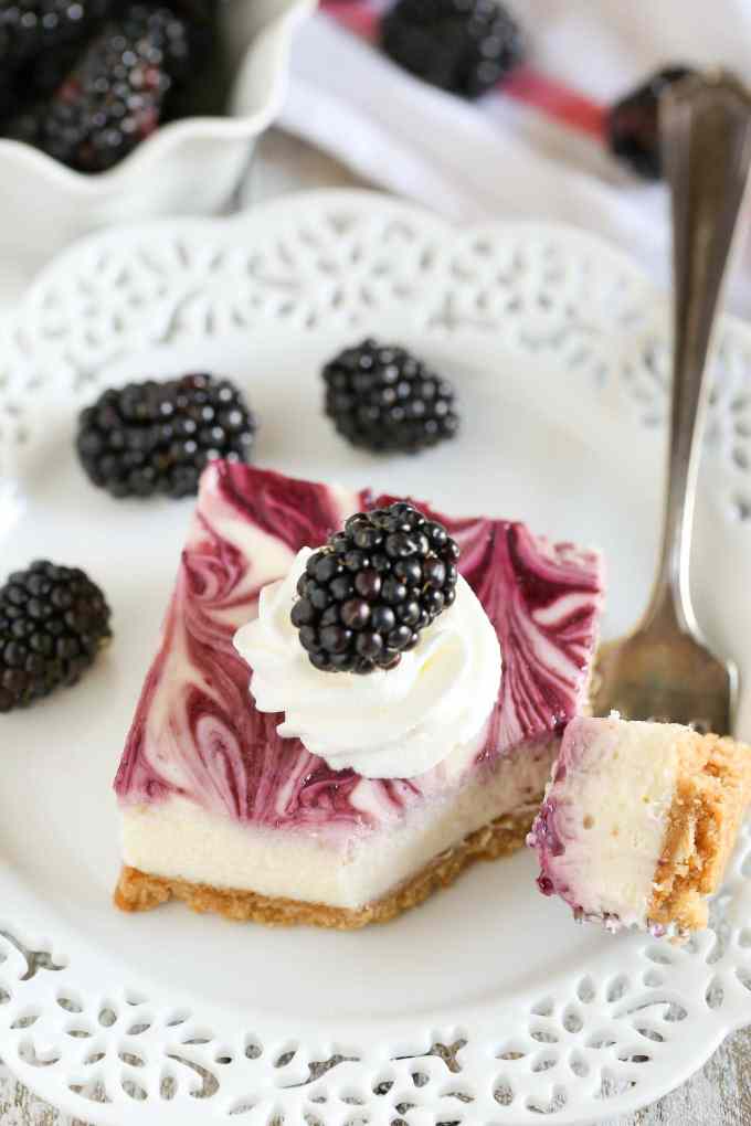 A homemade graham cracker crust topped with a smooth and creamy cheesecake filling and blackberry swirl. These Blackberry Swirl Cheesecake Bars make a gorgeous and delicious dessert!