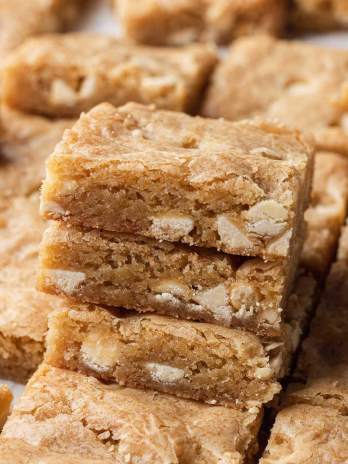 A stack of blondies with more sliced blondies around it.