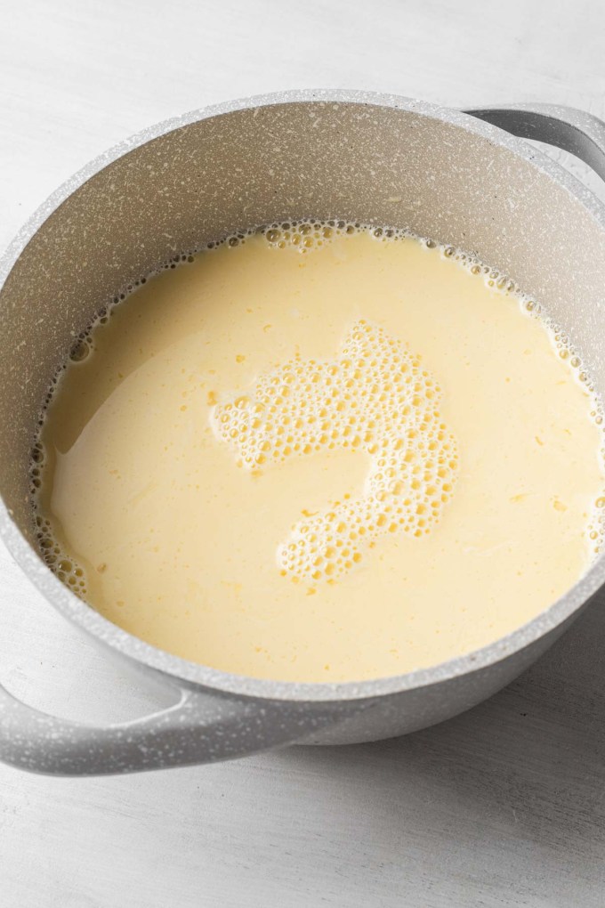 Uncooked pastry cream in a saucepan.