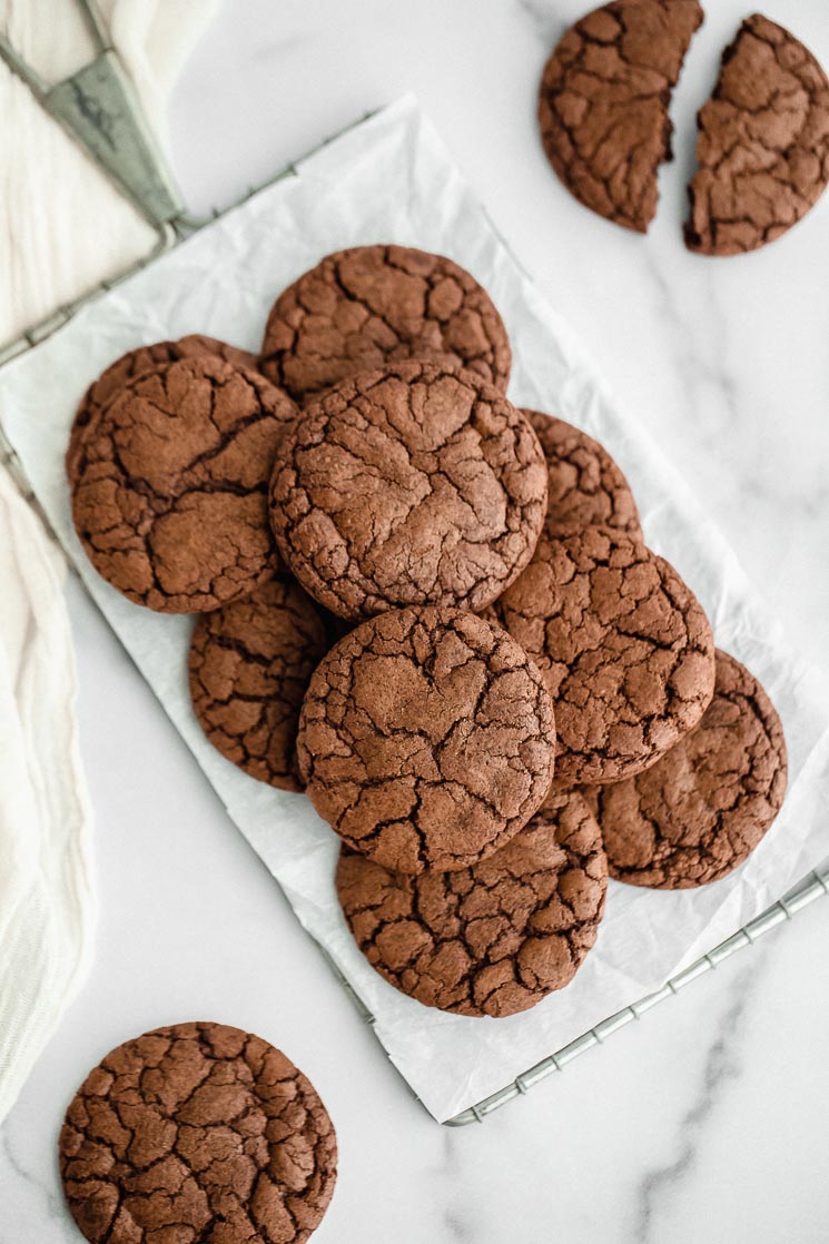 Brownie cookies on top of an antique safety grater with more cookies on the side.