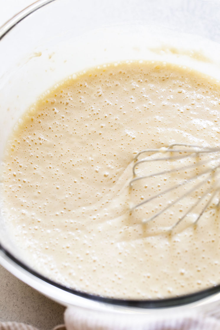 The wet ingredients being whisked together in a glass mixing bowl.