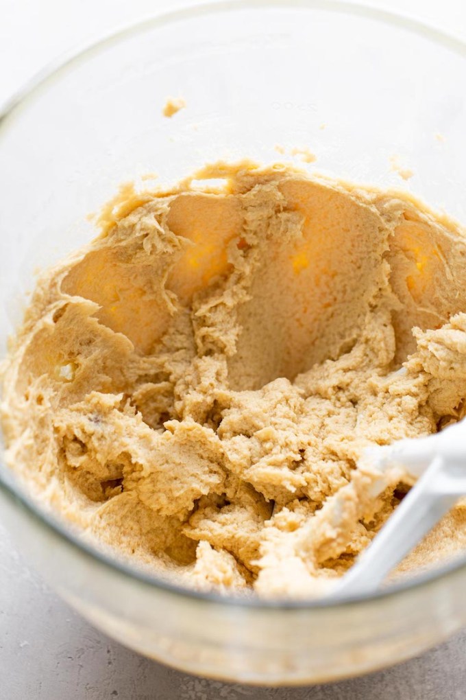 A glass mixing bowl of cookie dough.