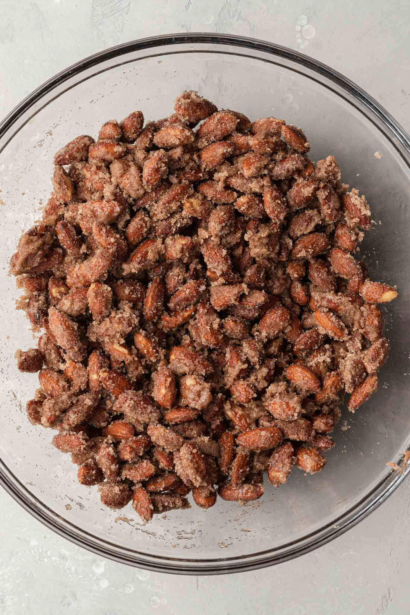 An overhead view of a candied almond mixture prior to baking. 