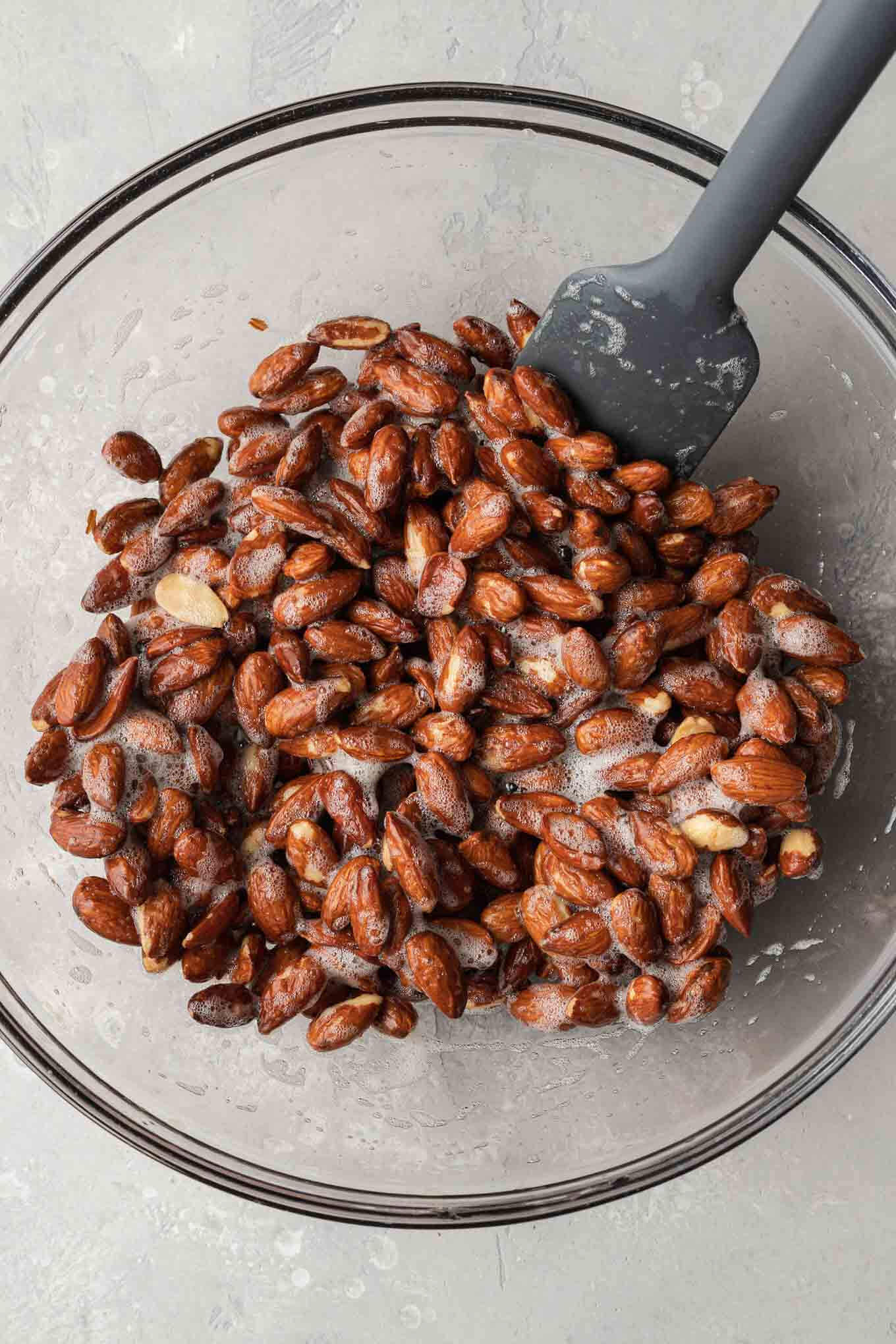 An overhead view of of raw almonds and egg whites. 