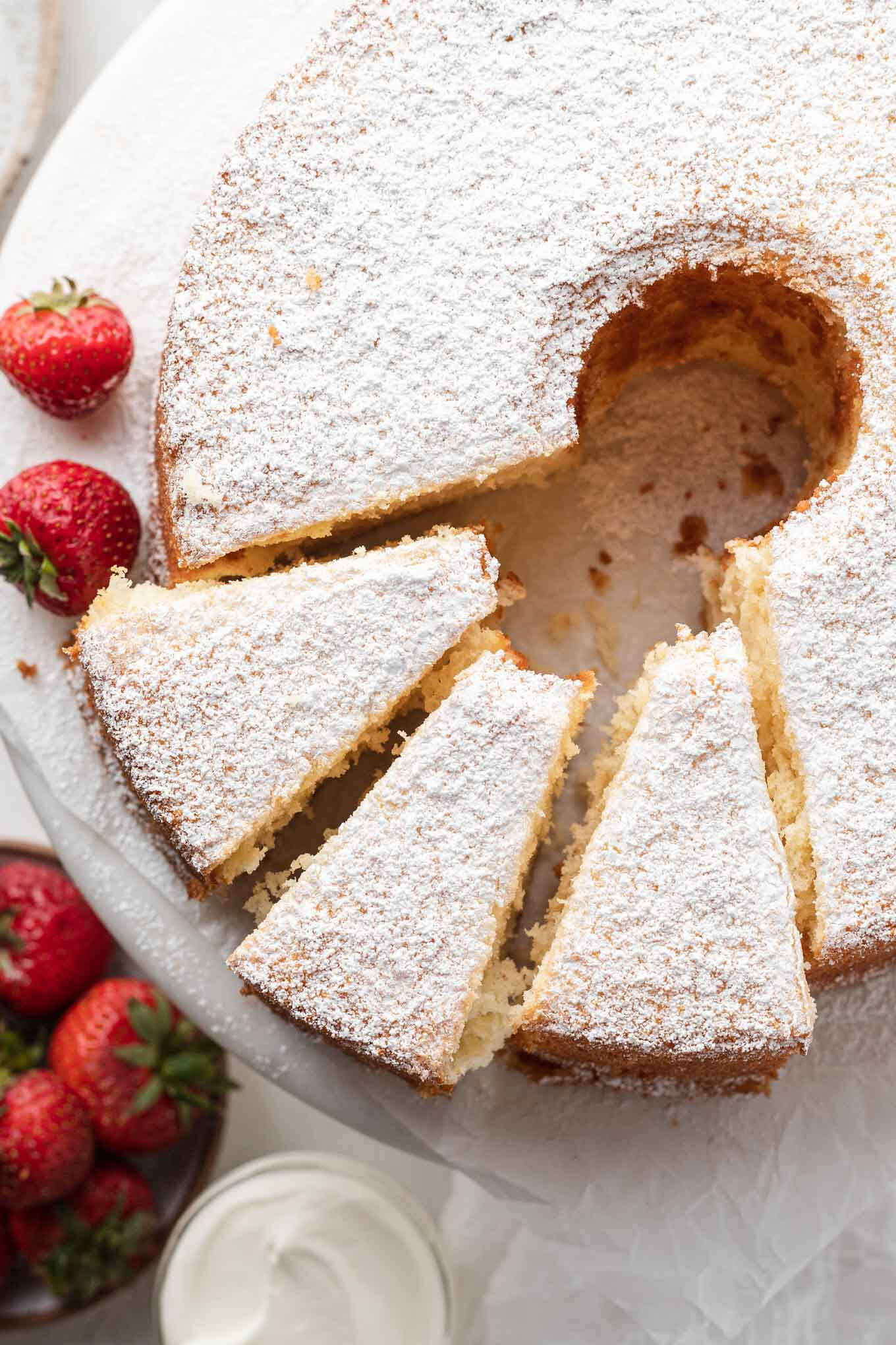 Overhead view of a chiffon cake, with three slices cut. 