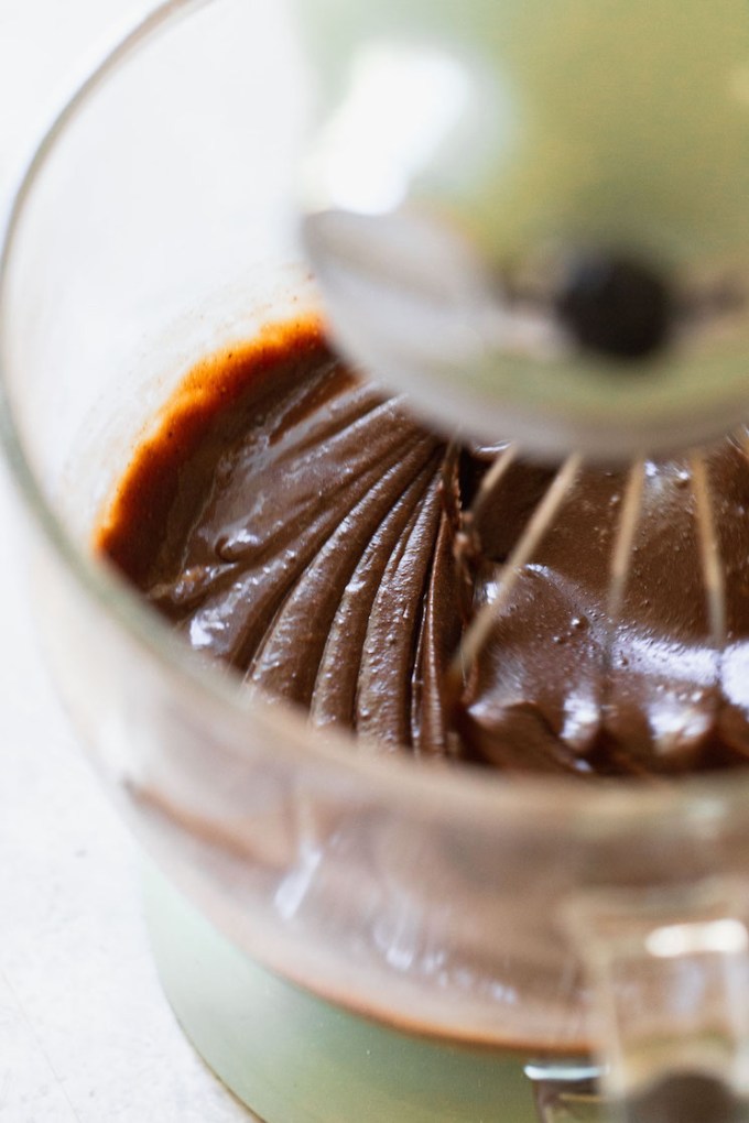 The dry ingredients and wet ingredients mixed together in a glass bowl.