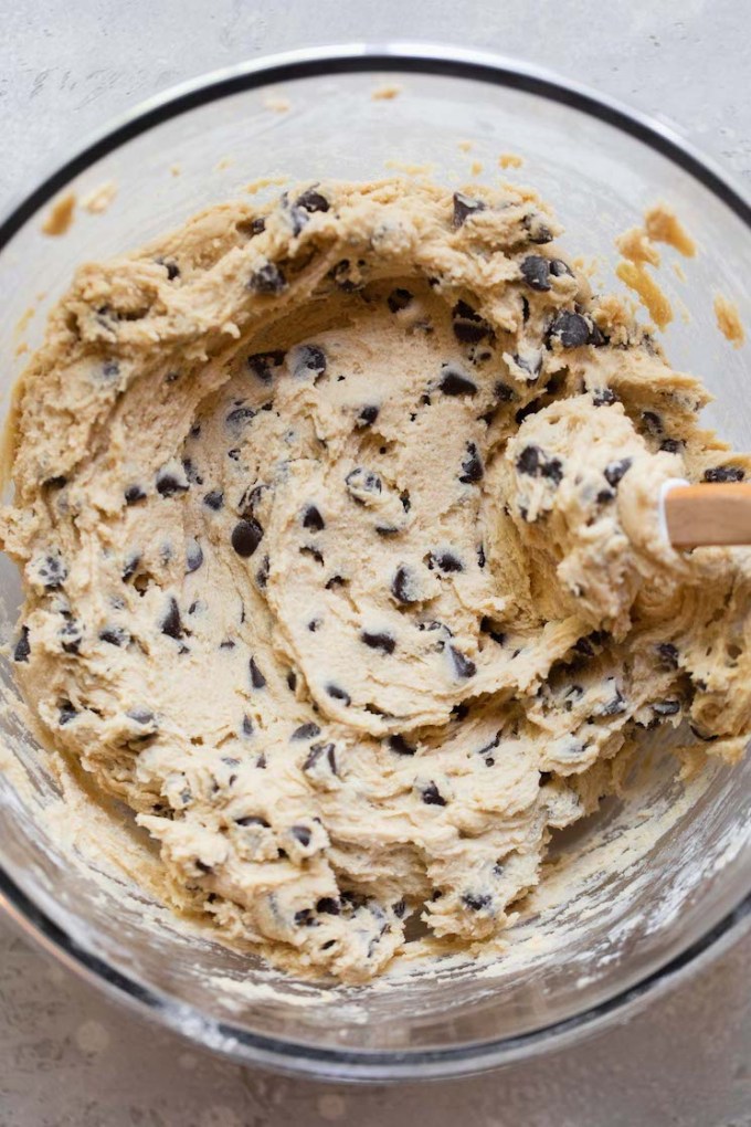 The finished cookie dough mixed up in a glass bowl.