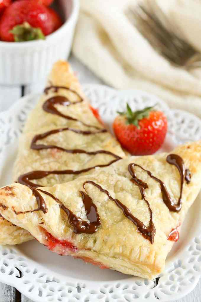 Puff pastry stuffed with chocolate, Nutella, and fresh strawberries. These Chocolate Strawberry Nutella Turnovers make one delicious and decadent dessert!