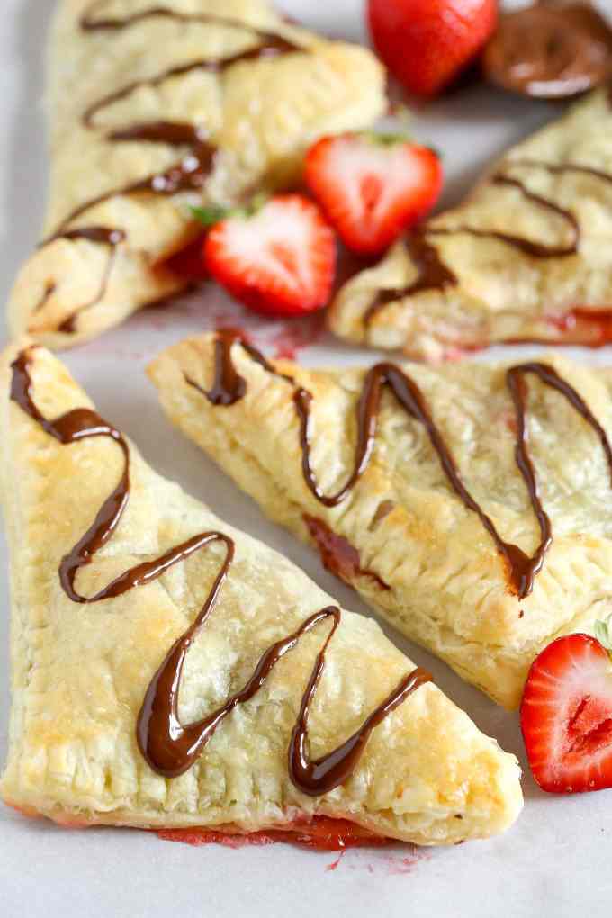 Puff pastry stuffed with chocolate, Nutella, and fresh strawberries. These Chocolate Strawberry Nutella Turnovers make one delicious and decadent dessert!