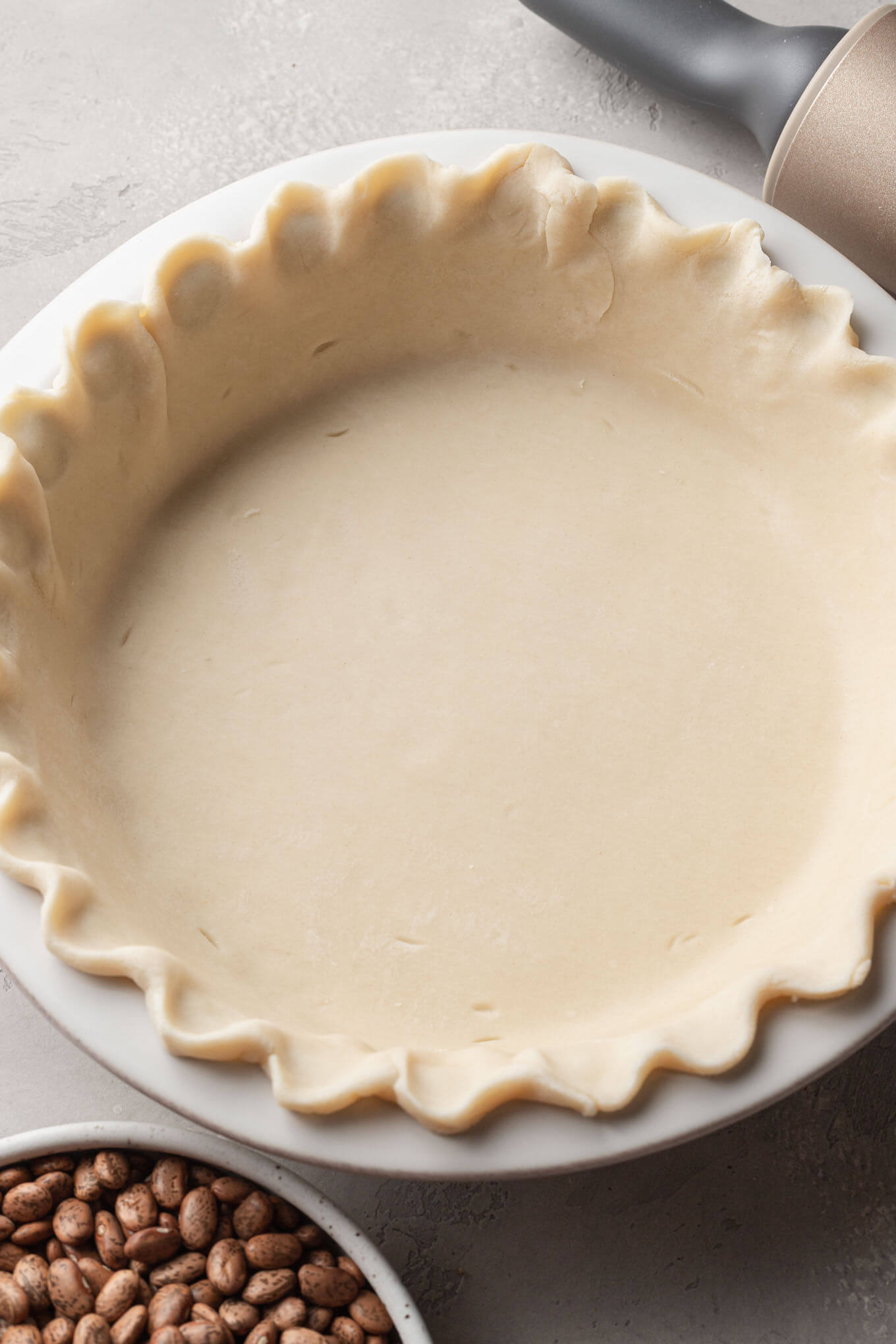 An overhead view of pie dough pressed into a pie plate. 