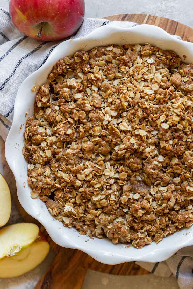 A finished apple crisp in a round baking dish.