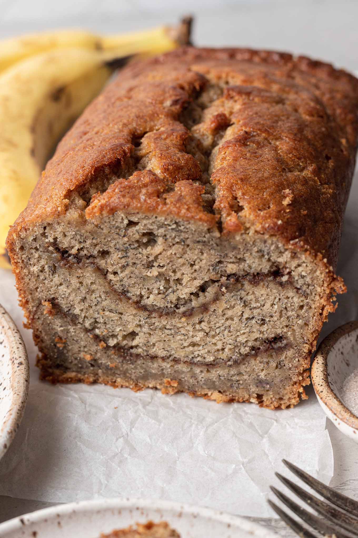 A loaf of banana bread with cinnamon swirls in the center.  