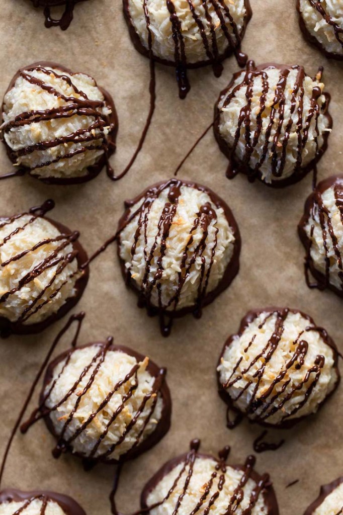 Overhead view of chocolate coconut macaroons on parchment paper. 