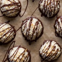 Overhead view of chocolate coconut macaroons on parchment paper.