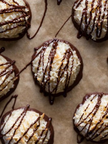 Overhead view of chocolate coconut macaroons on parchment paper.