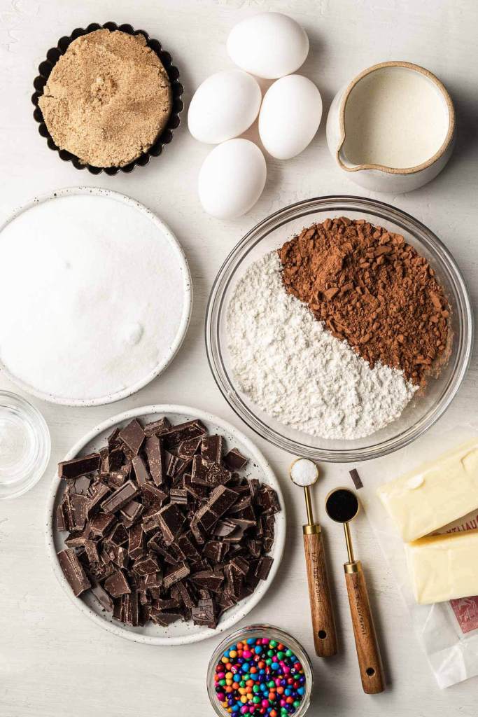 An overhead view of the ingredients needed to make fudgy brownies with chocolate frosting. 