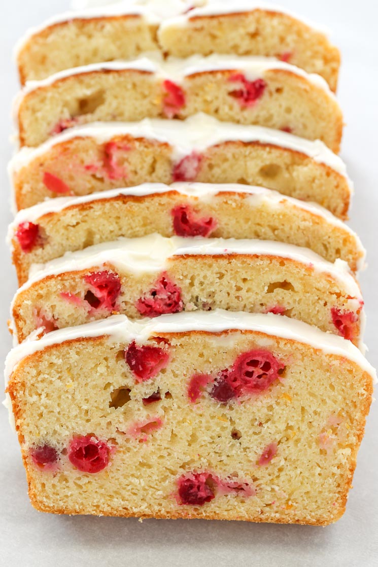 Six slices of cranberry orange loaf resting against one another. 