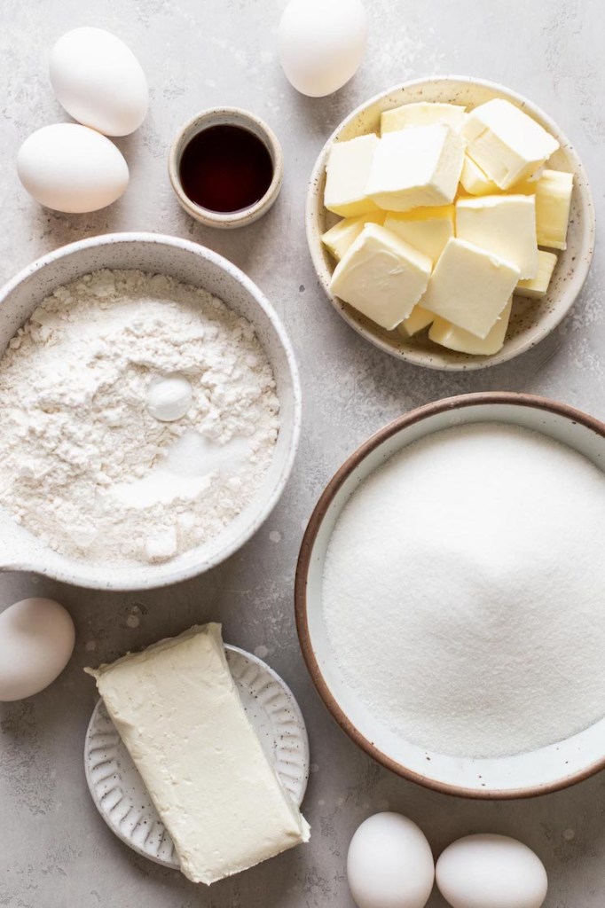 Overhead view of pound cake ingredients on a gray surface. 