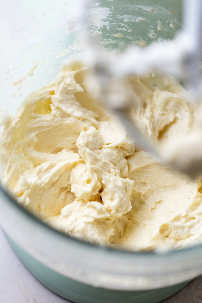 A glass mixing bowl holding the mixed wet ingredients for cookies.