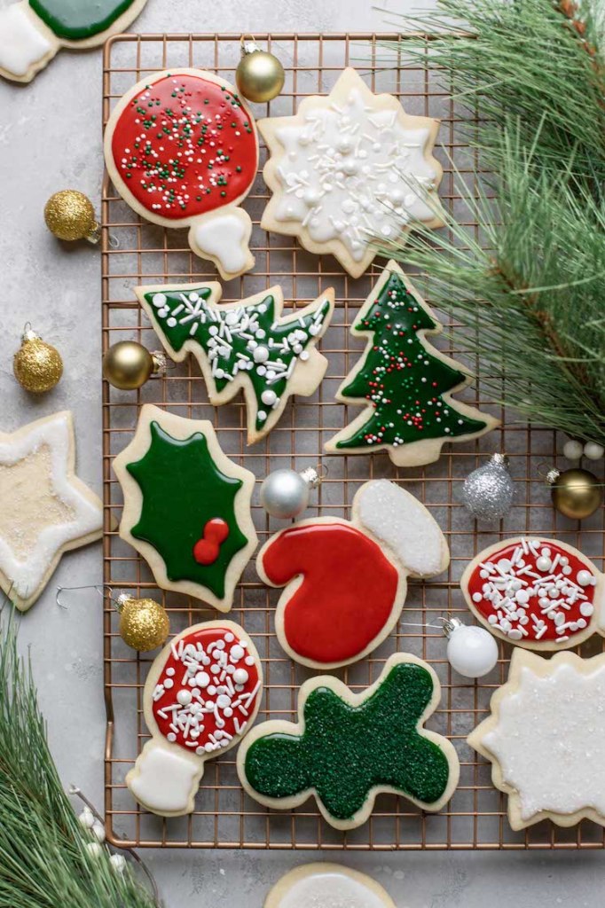 A cooling rack filled with decorated cut-out sugar cookies.