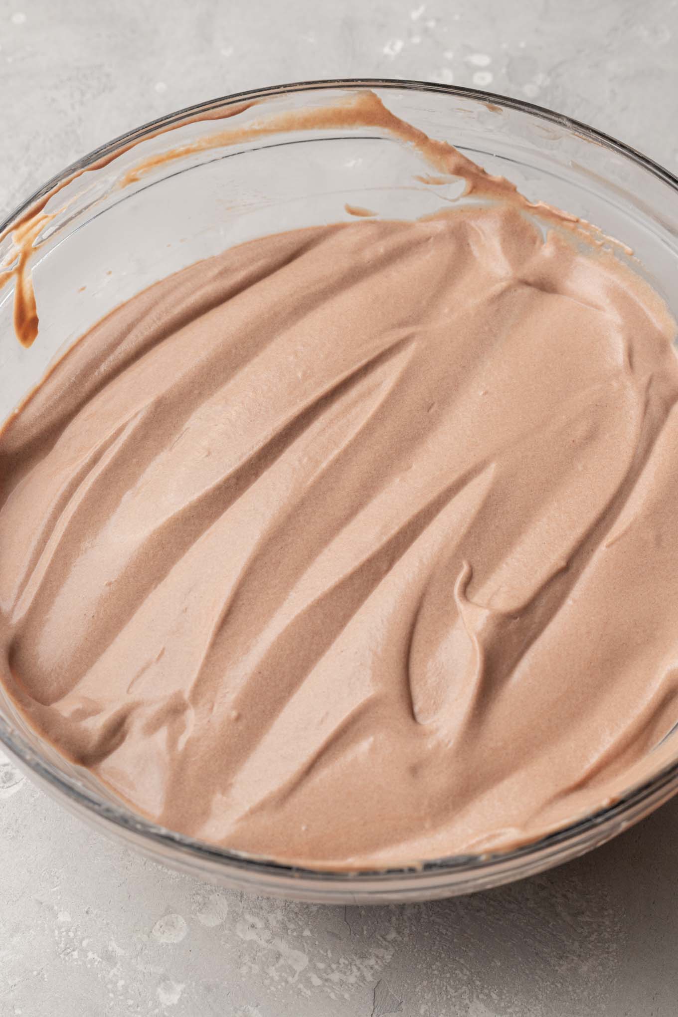 An overhead view of the chocolate pudding mixture with whipped cream folded into it.