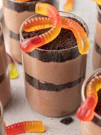 Several dirt cups topped with gummy worms.