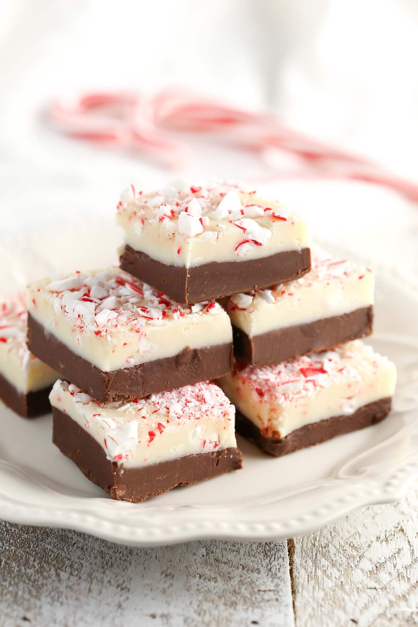 Stack of peppermint fudge on a white plate. 