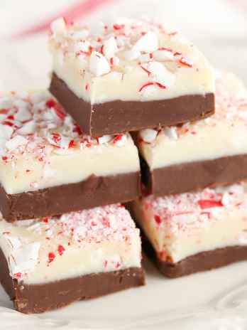 A stack of peppermint fudge on a decorative white plate.