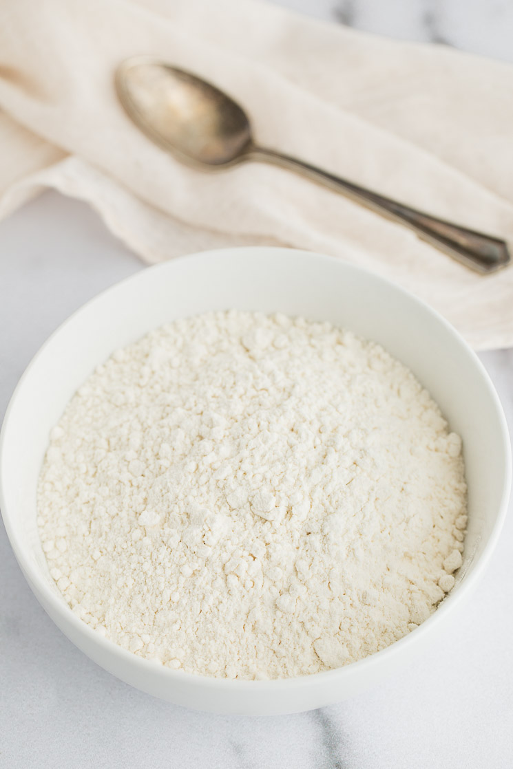 A white bowl filled with heat-treated flour.