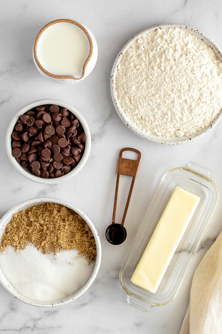 The ingredients for edible cookie dough on a marble surface.