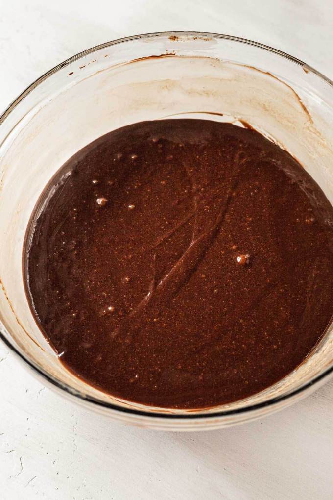 A silky chocolate filling in a glass mixing bowl.