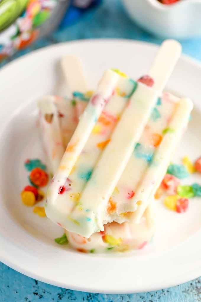 Three ingredient pudding pops filled with Marshmallow Fruity Pebbles! These Marshmallow Fruity Pebbles Pudding Pops make an easy and delicious treat!