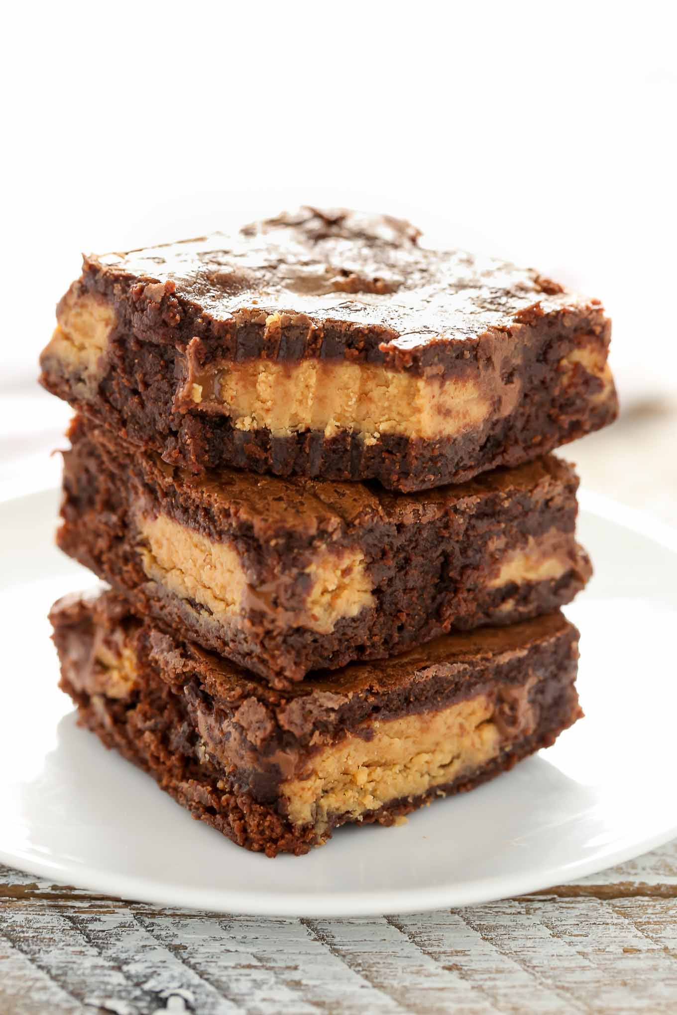 These Fudgy Peanut Butter Cup Brownies start with an easy homemade brownie recipe and are stuffed with peanut butter cups.  These fudgy brownies are the ultimate dessert!