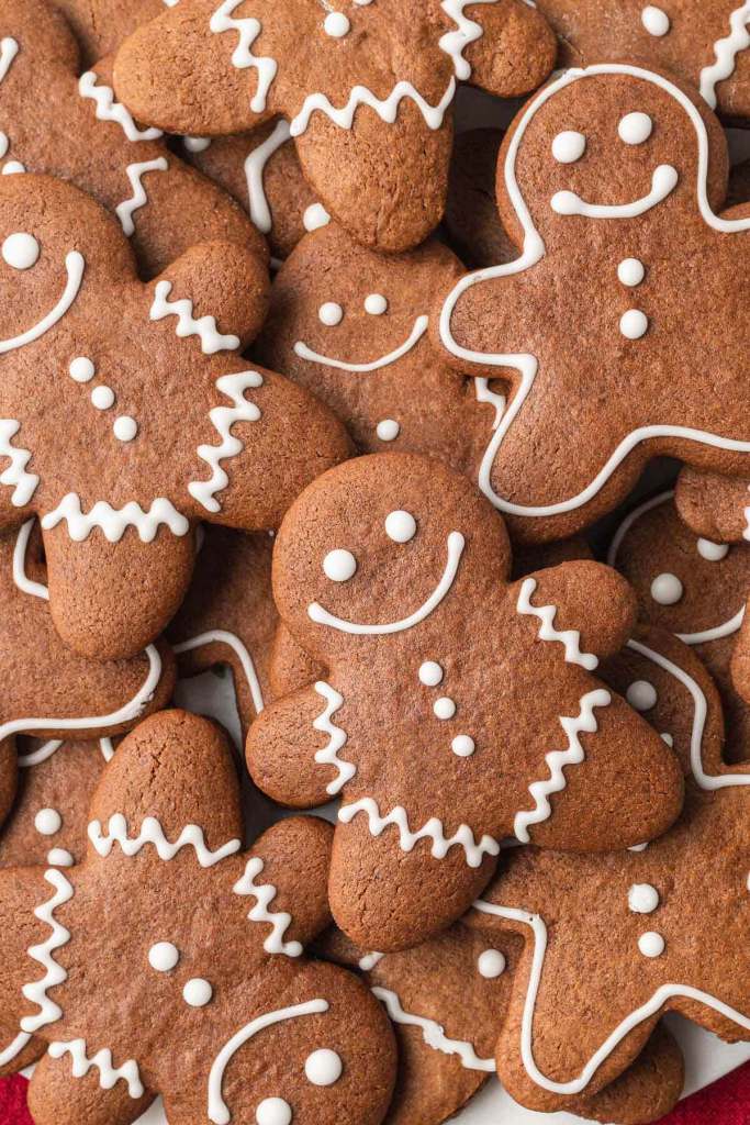 A close up, overhead view of a pile of gingerbread cutout cookies. 