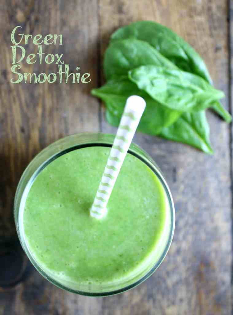 Overhead view of a spinach banana smoothie with a straw sticking out. 