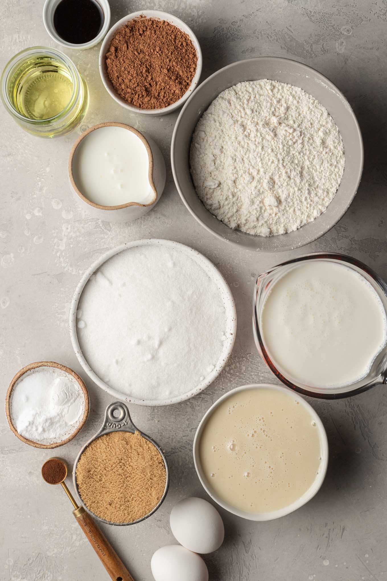 The ingredients needed for an ice cream cake on a gray surface.