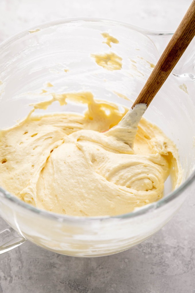 Cake batter mixed together in a large glass mixing bowl.